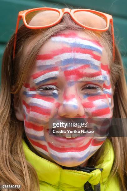 Girl with face paintings with Dutch national flags smiles during a celebration of the Koningsdag or the King's day April 27 in Katwijk, Netherlands....