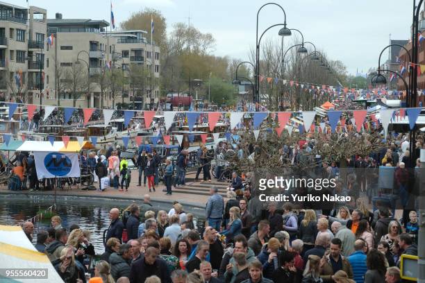 People gather during a celebration of the Koningsdag or the King's day April 27 in Katwijk, Netherlands. King's day is a national holiday,...