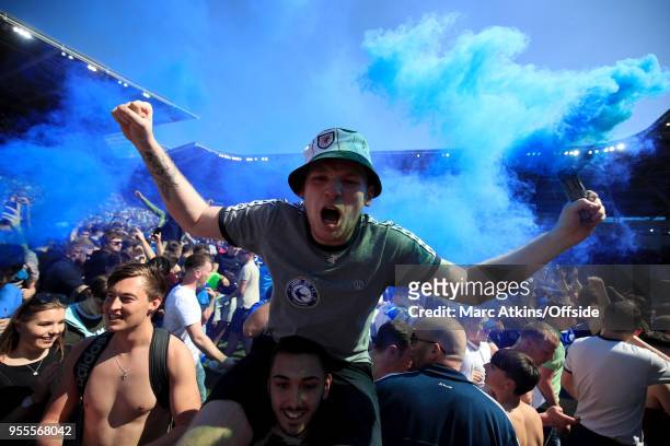 Cardiff City fan celebrates promotion holding a smoke bomb during the Sky Bet Championship match between Cardiff City and Reading at Cardiff City...