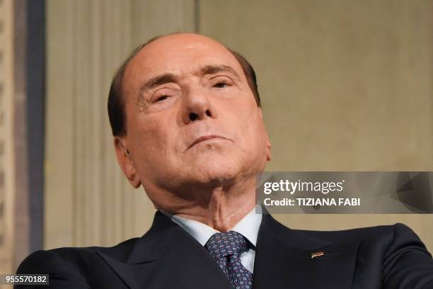 Silvio Berlusconi , leader of the right-wing party "Forza Italia" listens to Matteo Salvini , leader of the far-right party "Lega" speaking to the...