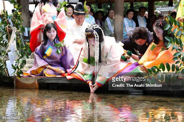 Shiho Sakashita, the Saiodai for this year's Aoi Festival, dips her fingers into the Mitarashigawa river that flows through Kamigamo Jinja Shrine on...