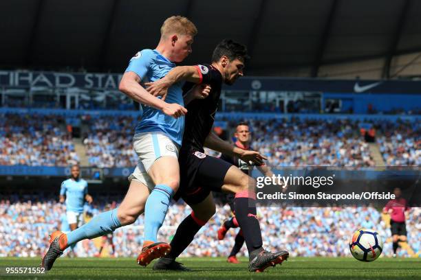 Kevin De Bruyne of Man City battles with Christopher Schindler of Huddersfield during the Premier League match between Manchester City and...