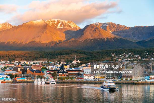 a tourist boat leaves the harbour of the southern most city in the world - ushuaia stock pictures, royalty-free photos & images