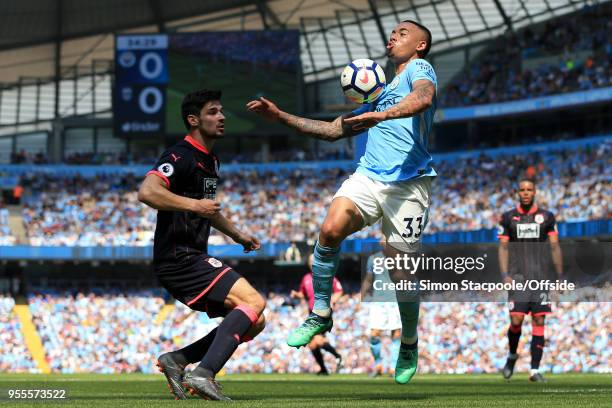 Gabriel Jesus of Man City battles with Christopher Schindler of Huddersfield during the Premier League match between Manchester City and Huddersfield...