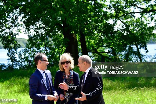 German Foreign Minister Heiko Maas and his French counterpart Jean-Yves Le Drian talk as they take a walk outside the German Foreign Ministry's Villa...