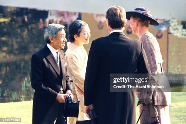 Emperor Akihito and Empress Michiko talk with Queen Margrethe II and her husband Prince Henrik of Denmark during the garden party celebrating his...