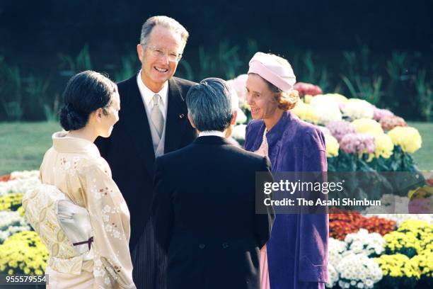 Emperor Akihito and Empress Michiko talk with King Baudouin and Queen Fabiola of Belgium during the garden party celebrating his Enthronement at the...