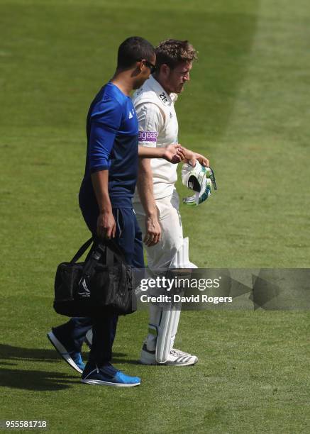 Liam Dawson of Hampshire leaves the field after an injury during day four of the Specsavers County Championship Division One match between...