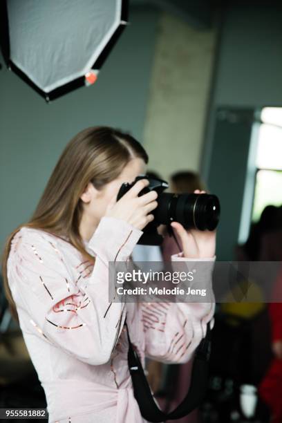 Model takes a photo on a camera backstage at Materiel by Materiel by Lado Bokuchava FW18 on May 6, 2018 in Tbilisi, Georgia.