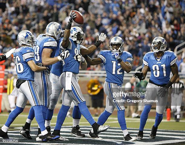 Bryant Johnson of the Detroit Lions celebrates a second quarter touchdown with Calvin Johnson and Derrick Williams while playing the Chicago Bears on...