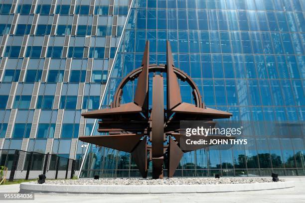 The symbol of North Atlantic Treaty Organization , a compass rose emblem, is pictured at the entrance of the new building housing the NATO...