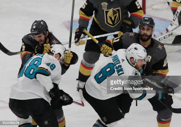 Vegas Golden Knights defenseman Colin Miller and left wing Pierre-Edouard Bellemare guard the goal against San Jose Sharks center Tomas Hertl and...