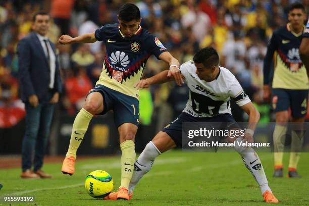 Joe Corona of America struggles for the ball against Pablo Barrera of Pumas during the quarter finals second leg match between America and Pumas UNAM...