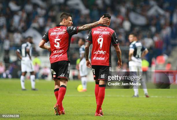 Damian Musto of Tijuana congratulates teammate Juan Lucero after scoring his team's second goal during the quarter finals second leg match between...