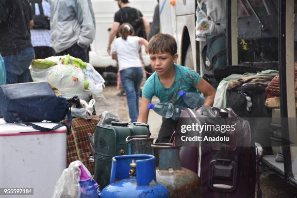 The fourth convoy carrying civilians depart from the Free Syrian Army controlled area of Yarmouk Camp in southern Damascus under the Yarmouk camp...