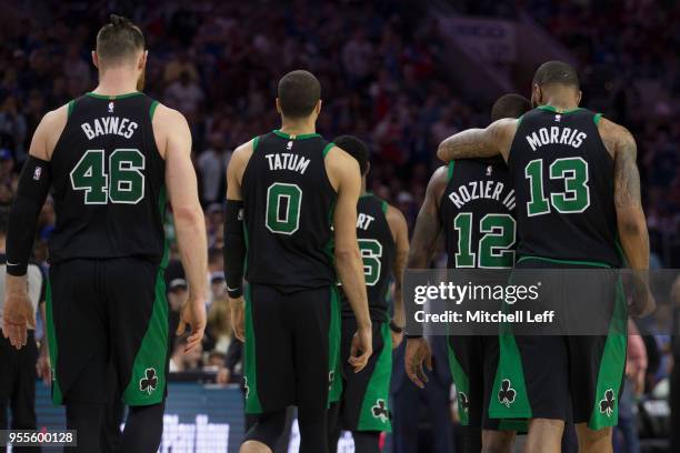 Aron Baynes, Jayson Tatum, Marcus Smart, Terry Rozier, and Marcus Morris of the Boston Celtics walk to the bench against the Philadelphia 76ers...