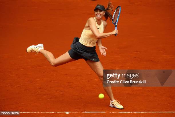 Maria Sharapova of Russia plays a forehand against Irina-Camelia Begu of Romania in their second round match during day three of the Mutua Madrid...