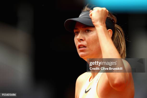 Maria Sharapova of Russia celebrates winning the first set against Irina-Camelia Begu of Romania in their second round match during day three of the...