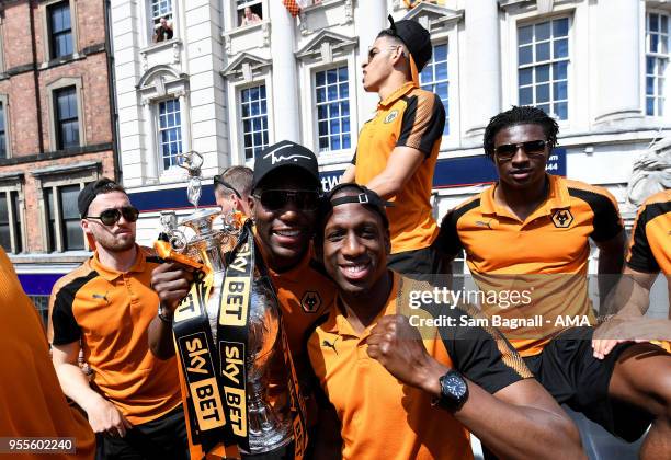 Benik Afobe of Wolverhampton Wanderers and Willy Boly during their celebrations of winning the Sky Bet Championship on a winners parade around the...