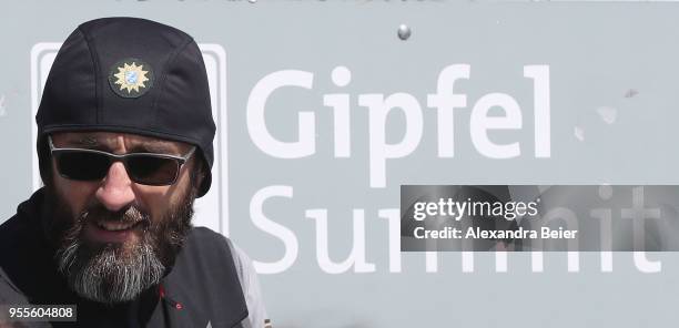 German policeman stands next to a sign reading 'Gipfel Summit' on top of the Zugspitze mountain on May 7, 2018 in Garmisch-Partenkirchen, Germany....