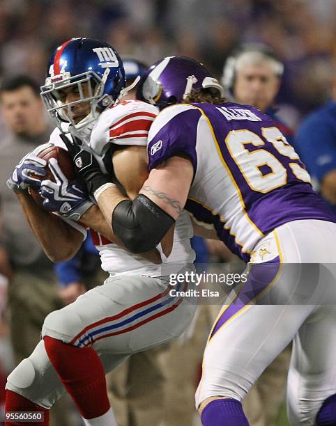 Travis Beckum of the New York Giants is tackled by Jared Allen of the Minnesota Vikingson January 3, 2010 at Hubert H. Humphrey Metrodome in...