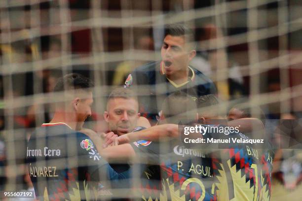 Matheus Uribe of America celebrates a scored goal with his teammates during the quarter finals second leg match between America and Pumas UNAM as...