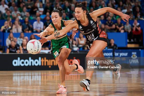 Verity Charles of the Fever competes for the loose ball against Madi Robinson of the Magpies during the round two Super Netball match between the...