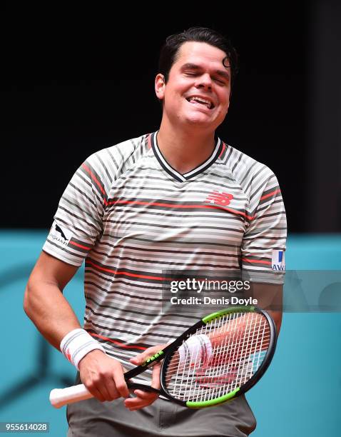 Milos Raonic of Canada smiles after winning a point against Nicolas Kicker of Argentina in their 1st Round during day three of the Mutua Madrid Open...