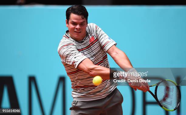 Milos Raonic of Canada returns a backhand to Nicolas Kicker of Argentina 1st Round of day three of the Mutua Madrid Open tennis tournament at the...
