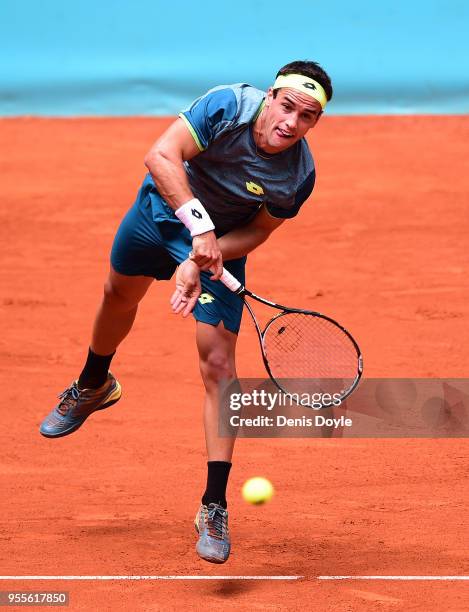 Nicolas Kicker of Argentina serves to Milos Raonic of Canada during his 1st Round match in day three of the Mutua Madrid Open tennis tournament at...