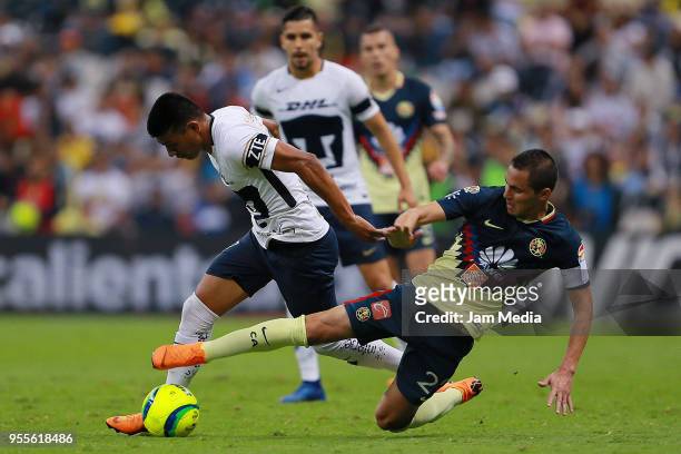 Jesus Gallardo of Pumas fights for the ball with Paul Aguilar of America during the quarter finals second leg match between America and Pumas UNAM as...