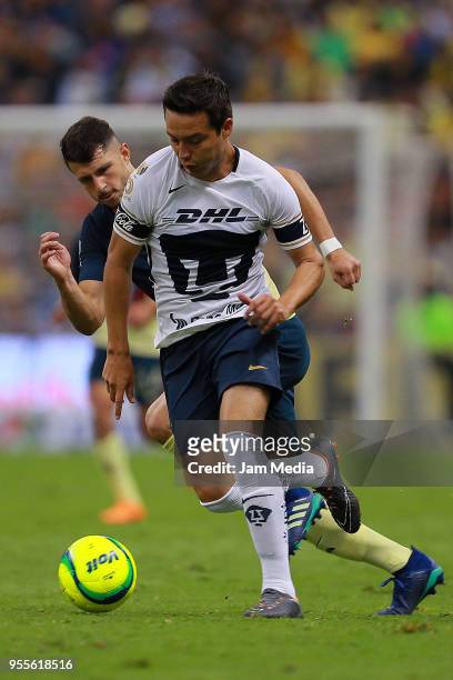Guido Rodriguez of America fights for the ball with Erick Torres of Pumas during the quarter finals second leg match between America and Pumas UNAM...