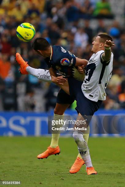 Joe Corona of America fights for the ball with Nicolas Castillo of Pumas during the quarter finals second leg match between America and Pumas UNAM as...