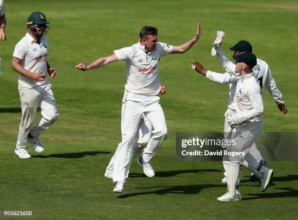 Jake Ball of Nottinghamshire celebrates with team mates after taking the wicket of Kyle Abbott during day four of the Specsavers County Championship...