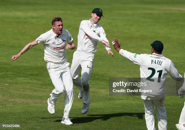 Jake Ball of Nottinghamshire celebrates with team mates after taking the wicket of Kyle Abbott during day four of the Specsavers County Championship...