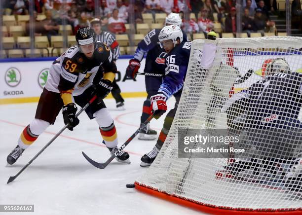 Colin White of United States and Manuel Wiederer of Gemany battle for the puck during the 2018 IIHF Ice Hockey World Championship group stage game...