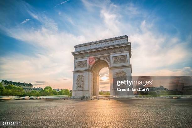 view of arc de triomphe in paris at sunset. - arc de triomphe parijs stockfoto's en -beelden