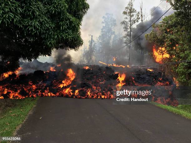 In this handout photo provided by the U.S. Geological Survey, a lava flow moves on Makamae Street after the eruption of Hawaii's Kilauea volcano on...