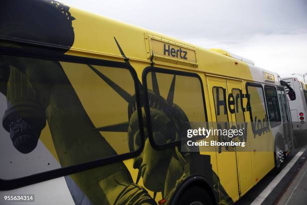 An image of the Statue of Liberty is displayed on a Hertz Global Holdings Inc. Shuttle bus at LaGuardia Airport in the Queens borough of New York,...