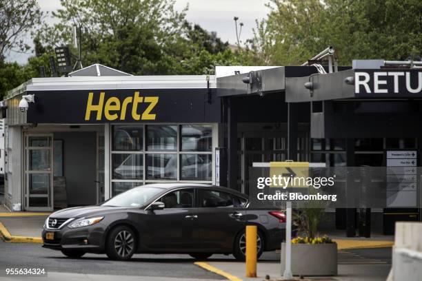 Vehicle exits from the Hertz Global Holdings Inc. Rental location at LaGuardia Airport in the Queens borough of New York, U.S., on Sunday, May 2018....