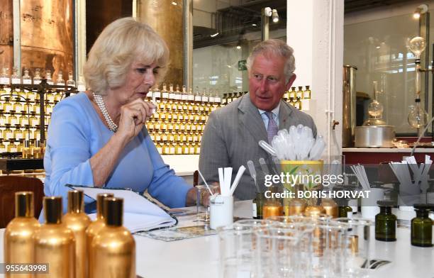 Britain's Prince Charles, Prince of Wales, and his wife Britain's Camilla, Duchess of Cornwall, create a perfume as they visit the Parfumerie...