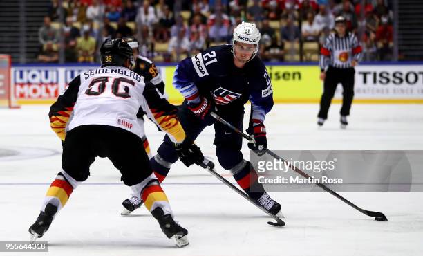 Dylan Larkin of United States and Yannic Seidenberg of Gemany battle for the puck during the 2018 IIHF Ice Hockey World Championship group stage game...