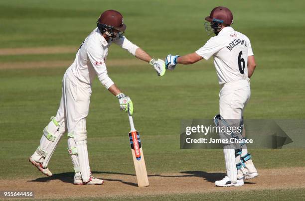 Ben Foakes of Surrey and Scott Borthwick of Surrey touch gloves as they celebrate a run during the Specsavers County Championship: Division One match...