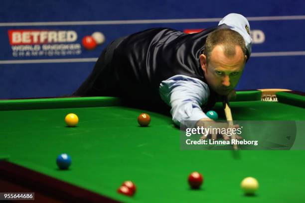 Mark Williams of Wales plays a shot during the third session of the final against John Higgins of Scotland during day seventeen of World Snooker...