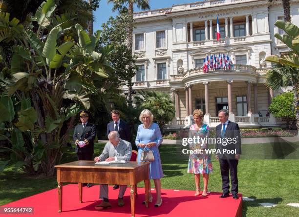 Prince Charles, Prince of Wales and Camilla, Duchess of Cornwal sign a book of condolence as Mr Christian Estrosi, Mayor of Nice and wife Laura...