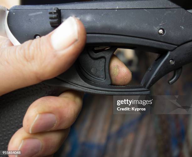 europe, greece, 2018: view of man holding speargun, finger on trigger - harpun bildbanksfoton och bilder