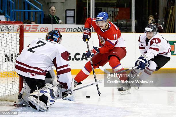 Andrej Nestrasil of Team Czech Republic shoots the puck on Janis Kalnins of Team Latvia during the 2010 IIHF World Junior Championship Tournament...