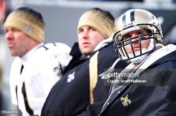 Drew Brees, Chase Daniel and Mark Brunell of the New Orleans Saints are seen on the bench during the game against the Carolina Panthers at Bank of...