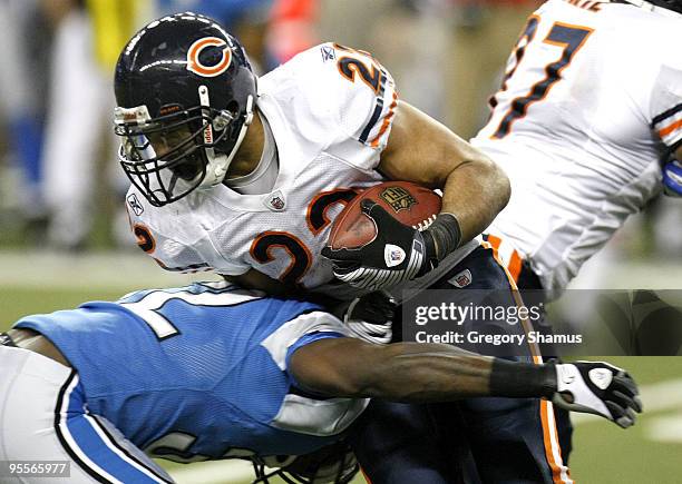 Matt Forte of the Chicago Bears is tackled during a fourth quarter run by Anthony Henry of the Detroit Lions on January 3, 2010 at Ford Field in...