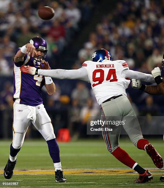 Brett Favre of the Minnesota Vikings passes the ball under pressure from Mathias Kiwanuka of the New York Giants on January 3, 2010 at Hubert H....